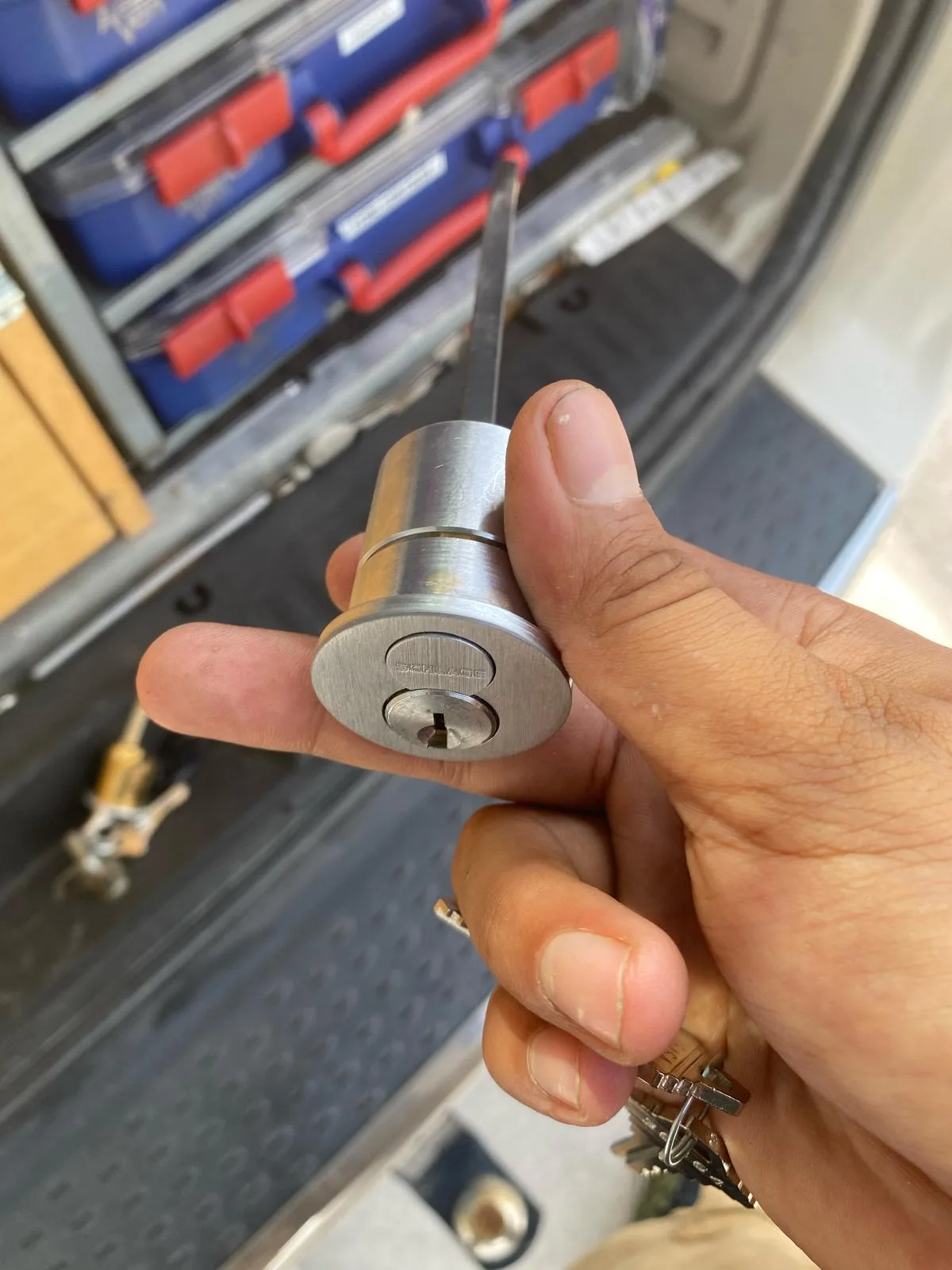 A Local Locksmith Pros LLC technician holding a high-security deadbolt cylinder, ready for a professional Deadbolt Installation service.