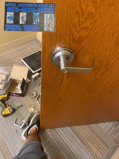 Lock Replacement by Local Locksmith Pros LLC, featuring a newly installed cylindrical lever handle and various tools on the floor from the installation process.