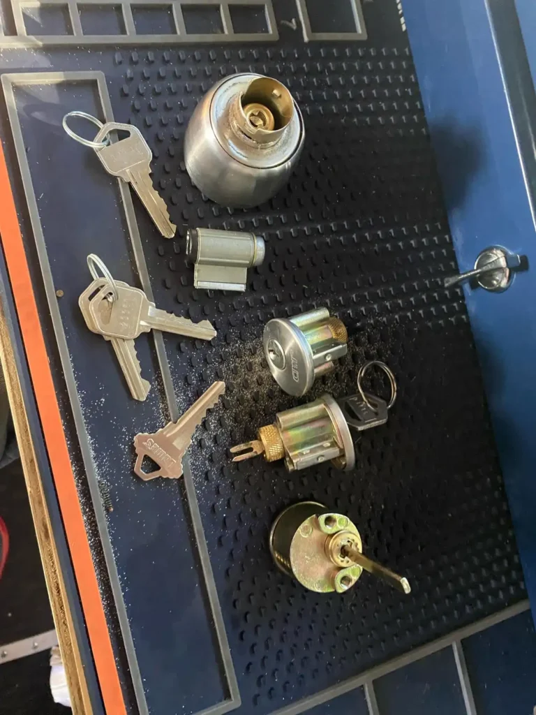 Close-up of lock cylinders and keys laid out for a professional Residential Lock Rekeying service by Local Locksmith Pros LLC.