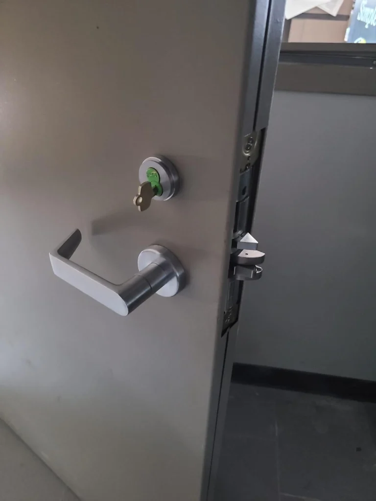 A newly installed lever handle and a fresh deadbolt with a key inserted, showcasing a complete Residential Lock Replacement by Local Locksmith Pros LLC.